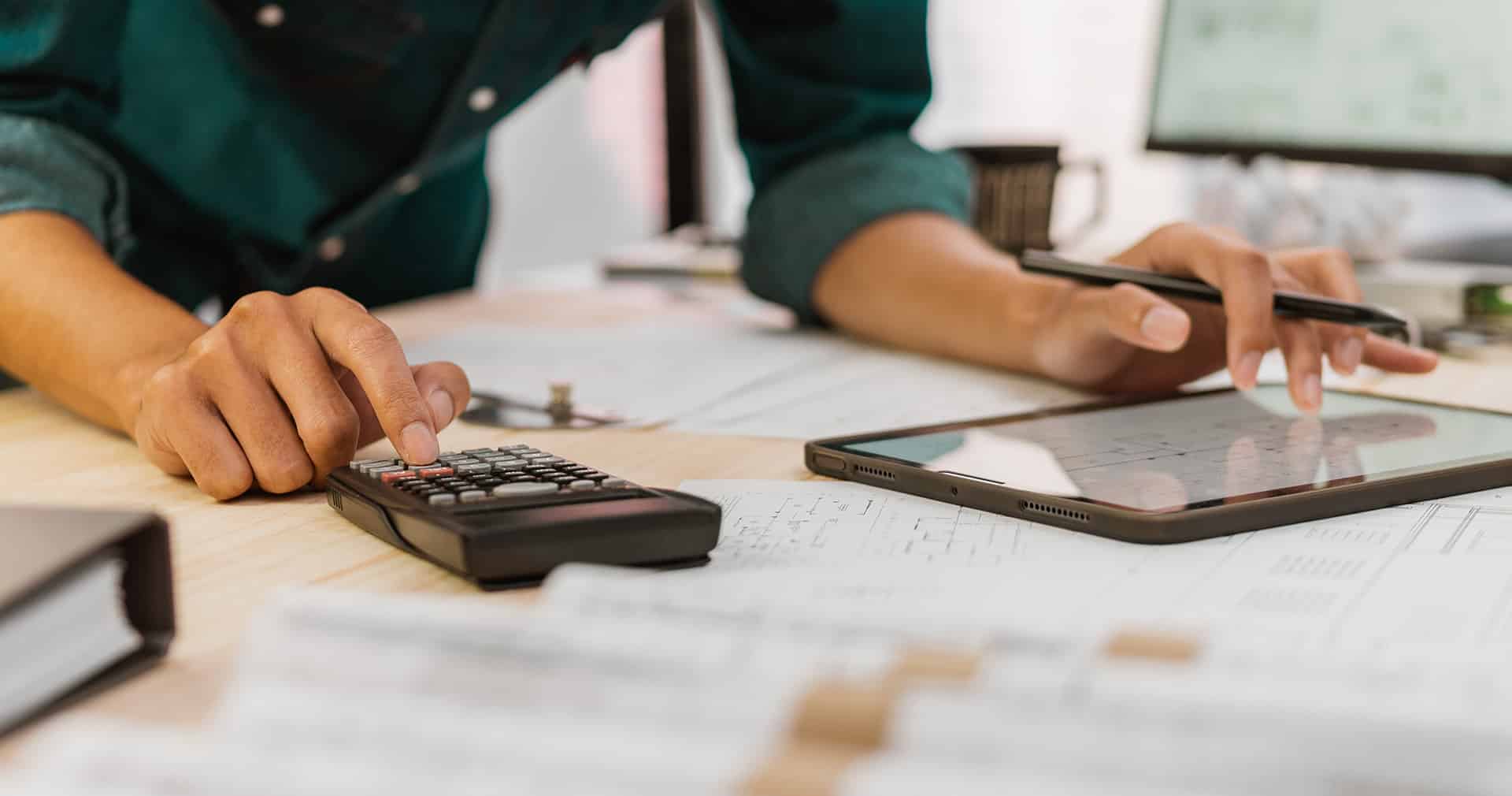 Construction estimator using calculator and ipad to make cost estimate